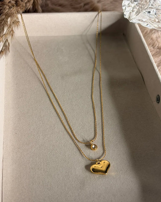 Double Layered Necklace With a Heart Pendant and a Stone